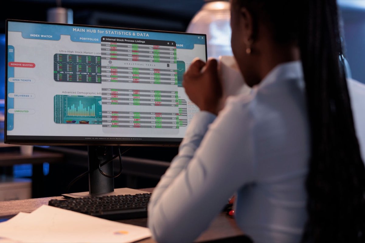 IT consultant working across several screens